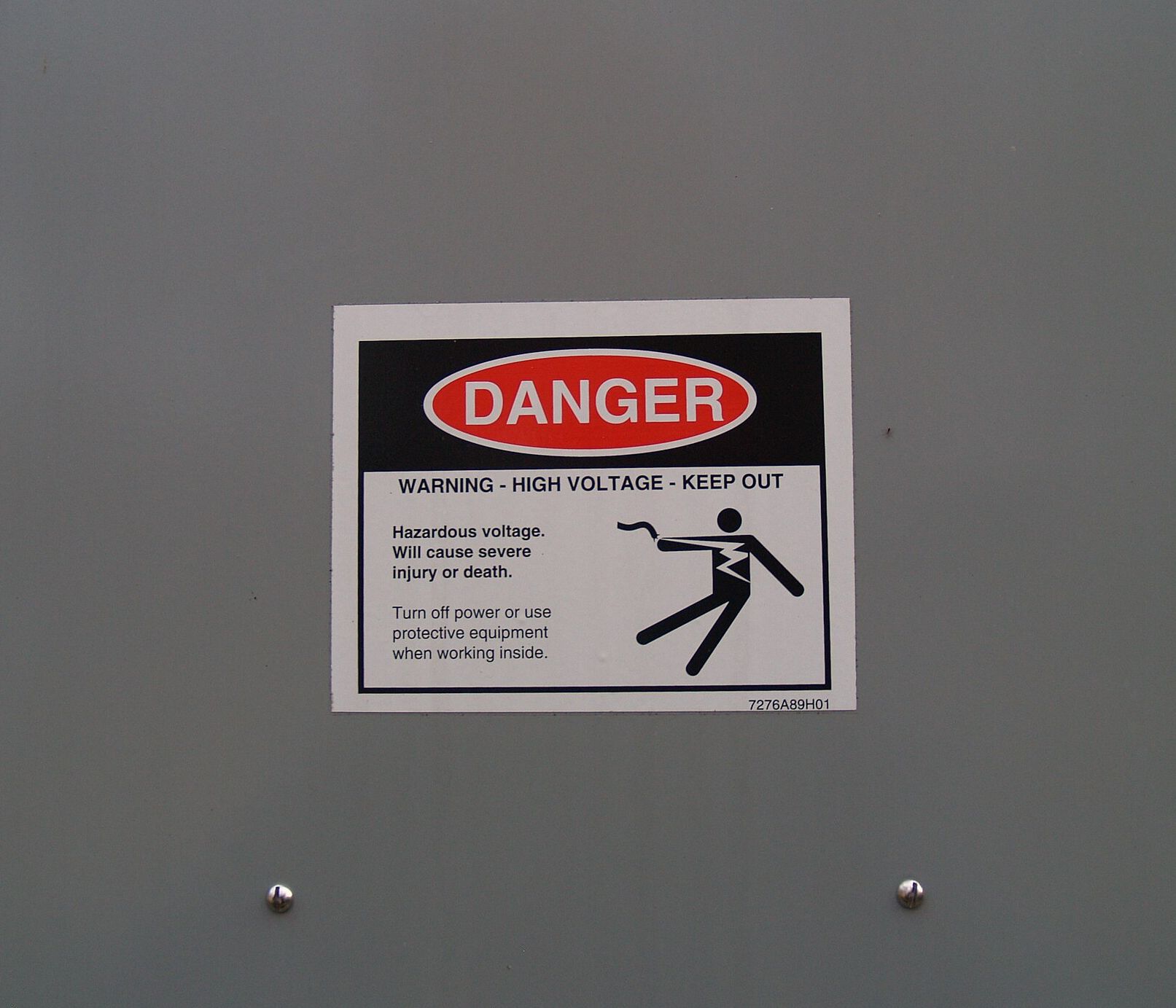 Danger high voltage label on a gray steel panel