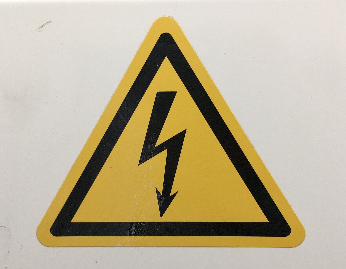 Yellow high voltage warning triangle on a fuse box